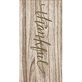 Luncheon style napkin with woodgrain print and thankful written in script letters
